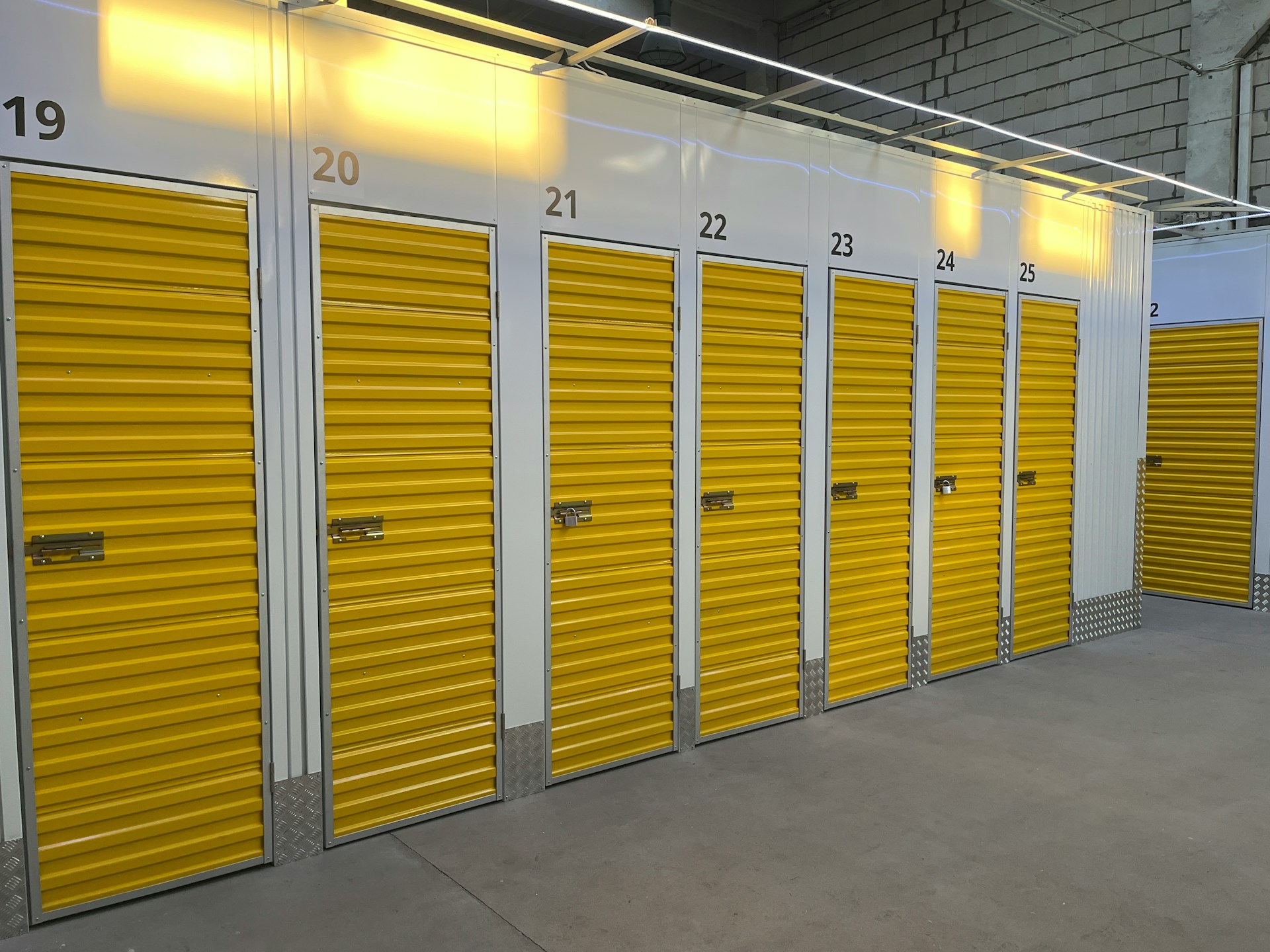Interior of a climate control storage unit with shelves, labeled boxes, and stable temperature settings to protect sensitive items.